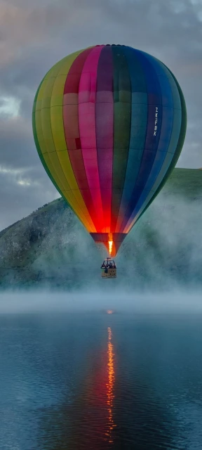 Colorful hot air balloon over water