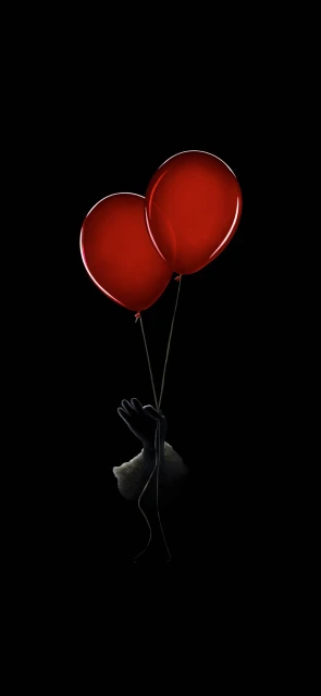 Hand Holding Red Balloons