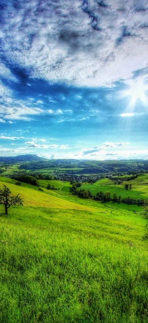 Green Rolling Hills Under Blue Sky