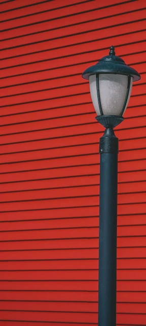 Street Lamp Against Red Wall