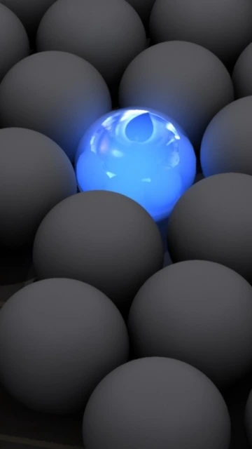 Blue Glowing Sphere Among Gray Spheres